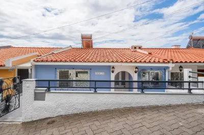 a blue and white house with a balcony at Terrace Vila II by An Island Apart in Santa Cruz