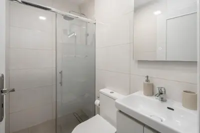 a bathroom with a toilet and a sink and a shower at Terrace Vila II by An Island Apart in Santa Cruz