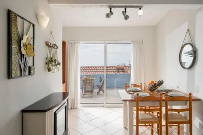 a kitchen and dining room with a table and chairs at Terrace Vila II by An Island Apart in Santa Cruz