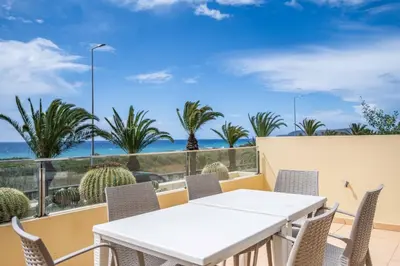 a table and chairs on a balcony with a view of the ocean at Casa das Pedras Pretas - By WeHost in Porto Santo