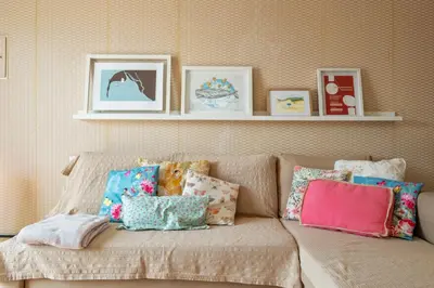 a couch with a bunch of pillows on it at Casa das Pedras Pretas - By WeHost in Porto Santo