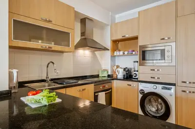a kitchen with a sink and a dishwasher at Casa das Pedras Pretas - By WeHost in Porto Santo