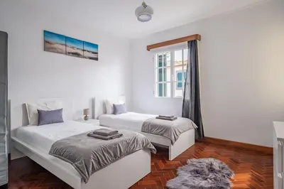 a bedroom with two beds and a window at The Balcony - By Wehost in Santa Cruz