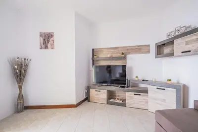a living room with a large wooden entertainment center at The Balcony - By Wehost in Santa Cruz