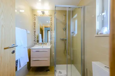 a bathroom with a shower and a sink at Boavista Golf and Spa Resort - Bayview in Lagos