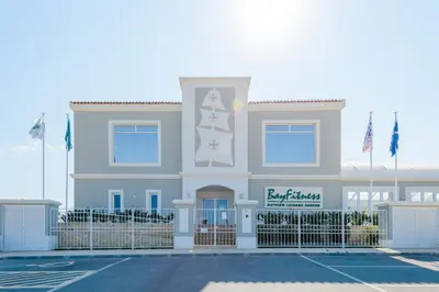 a large white building with flags in front of it at Boavista Golf and Spa Resort - Bayview in Lagos