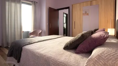 a bedroom with a bed with pillows on it at Village Center One Bedroom Apartment in Porto Moniz