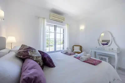 a bedroom with a bed with two stuffed animals on it at CoolHouses Algarve Lagos, 4 bed single-story House, pool and amazing panoramic views, Casa Fernanda in Lagos