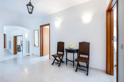 a dining room with two chairs and a table at CoolHouses Algarve Lagos, 4 bed single-story House, pool and amazing panoramic views, Casa Fernanda in Lagos