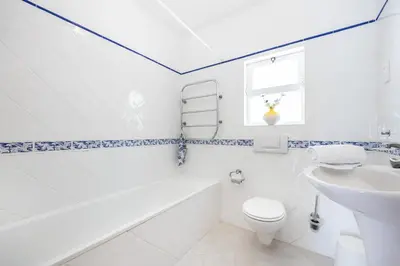 a white bathroom with a toilet and a sink at CoolHouses Algarve Lagos, 4 bed single-story House, pool and amazing panoramic views, Casa Fernanda in Lagos