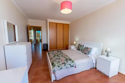 a bedroom with a bed and two night stands at Vista Mar in Porto Santo