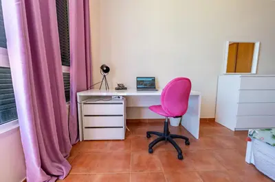 an office with a pink chair and a desk at Vista Mar in Porto Santo