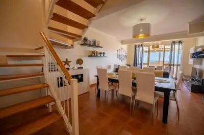 a dining room and kitchen with a table and chairs at Vista Mar in Porto Santo