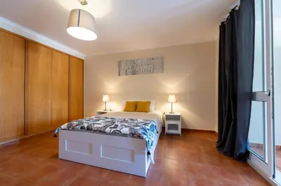 a bedroom with a bed and a large window at Vista Mar in Porto Santo
