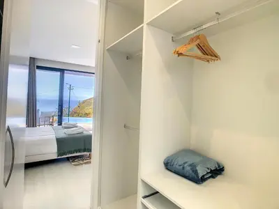 a bedroom with a view of a bed and a window at Noah - Private Sunset Hideaway by LovelyStay in Arco da Calheta