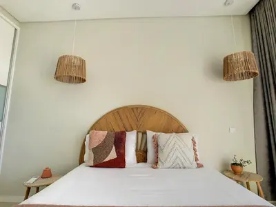 a bedroom with a bed with two pendant lights at Noah - Private Sunset Hideaway by LovelyStay in Arco da Calheta