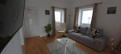 a living room with a couch and a table at House Nobrega of Madeira in Arco da Calheta