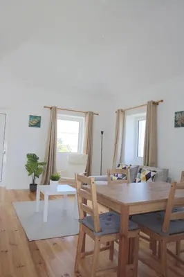 a dining room with a wooden table and chairs at House Nobrega of Madeira in Arco da Calheta