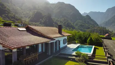 a house with a swimming pool and mountains in the background at Quinta do Conde by LovelyStay in Boaventura