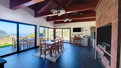 a kitchen and dining room with a table and chairs at Quinta do Conde by LovelyStay in Boaventura
