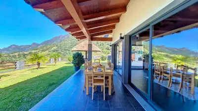 a patio with a table and chairs on a house at Quinta do Conde by LovelyStay in Boaventura
