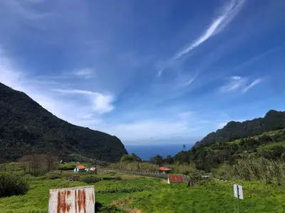 a view of the ocean from a field with mountains at Quinta do Conde by LovelyStay in Boaventura