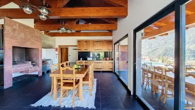 a kitchen and dining room with a table and chairs at Quinta do Conde by LovelyStay in Boaventura