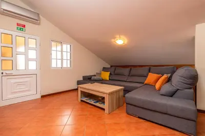 a living room with a couch and a table at CASA POR DO SOL in Calheta