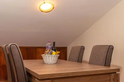 a dining room table with chairs and a basket of fruit at CASA POR DO SOL in Calheta