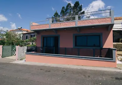 a small house on the side of a street at Casa do Brasileiro in Arco da Calheta