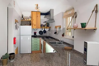 a kitchen with a white refrigerator and a sink at 205 Casa Cactus in Sagres