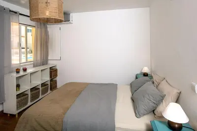 a small bedroom with a bed and a window at 205 Casa Cactus in Sagres