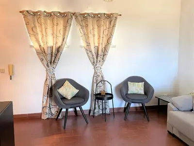 a living room with a couch and a table at Apartamento vista mar e pôr do Sol (1,6km Praia) in Aljezur