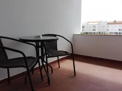 a table and chairs in a room with a window at Apartamento vista mar e pôr do Sol (1,6km Praia) in Aljezur