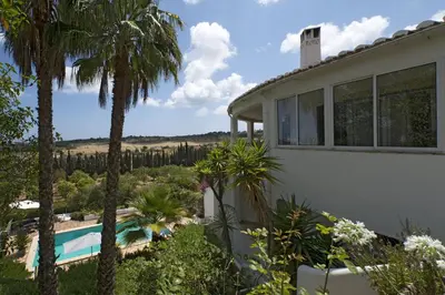 a house with a swimming pool and palm trees at 607 Villa Lorena in Lagos