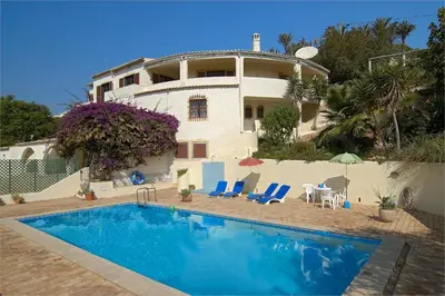 a house with a swimming pool in front of it at 607 Villa Lorena in Lagos