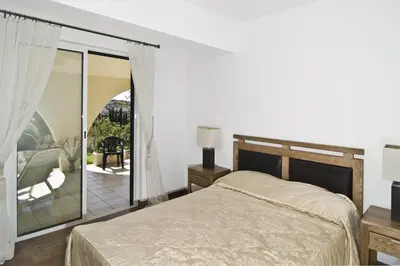 a bedroom with a large bed and a balcony at 607 Villa Lorena in Lagos