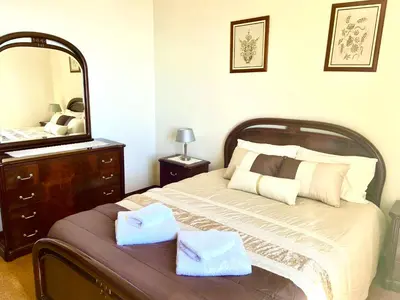 a bedroom with two beds and a window at Casa Neves three bedrooms and fantastic sea view in Arco da Calheta