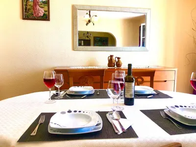 a table and chairs with an umbrella on a balcony at Casa Neves three bedrooms and fantastic sea view in Arco da Calheta