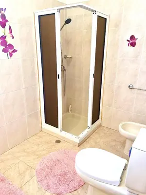 a kitchen with wooden cabinets and a table and a sink at Casa Neves three bedrooms and fantastic sea view in Arco da Calheta