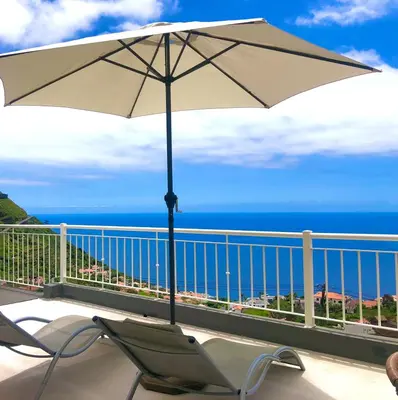 a bathroom with a shower with a toilet and a rug at Casa Neves three bedrooms and fantastic sea view in Arco da Calheta