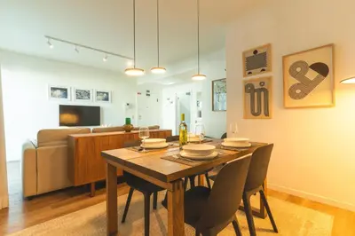 a dining room and living room with a table and chairs at Terrace Apartment by Atlantic Holiday in Funchal