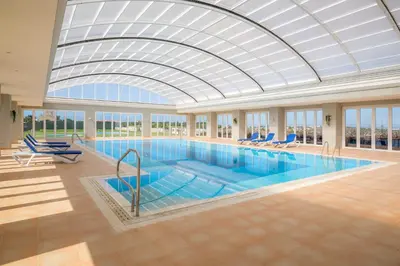 a large swimming pool with a glass ceiling at Casa Malhotra at Boa Vista Golf Resort, Bayview Village in Lagos