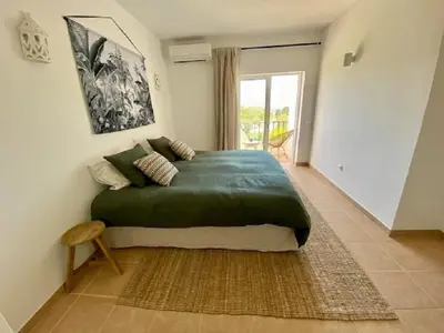 a bedroom with a large bed in a room at Serenity bright flat T3, 2 terraces seaview 600m beach in Luz