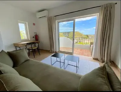 a living room with a couch and a large window at Serenity bright flat T3, 2 terraces seaview 600m beach in Luz