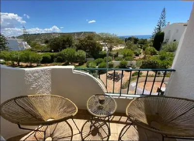 two chairs sitting on a balcony with a view at Serenity bright flat T3, 2 terraces seaview 600m beach in Luz