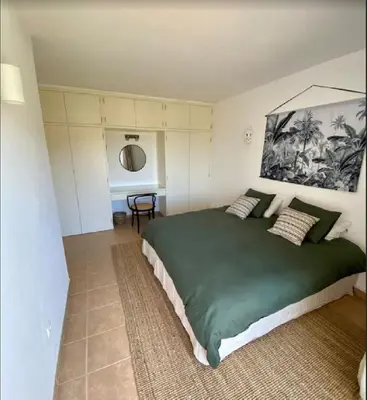 a bedroom with a large green bed in a room at Serenity bright flat T3, 2 terraces seaview 600m beach in Luz