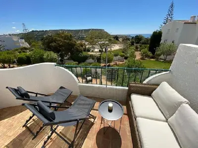 a balcony with a couch and chairs and a table at Serenity bright flat T3, 2 terraces seaview 600m beach in Luz