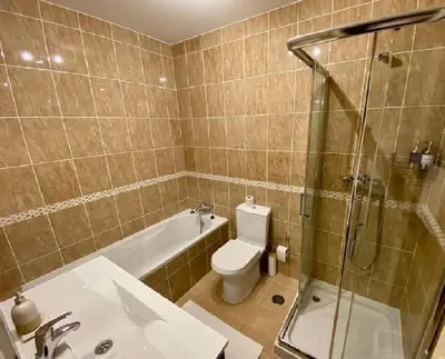 a bathroom with a sink and a toilet and a shower at Serenity bright flat T3, 2 terraces seaview 600m beach in Luz