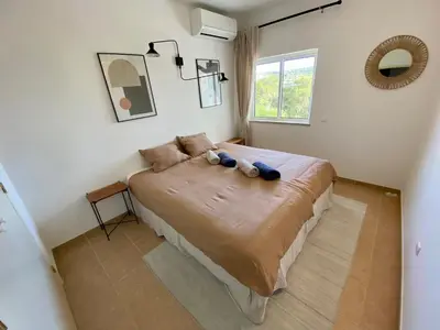 a bedroom with a large bed in a room at Serenity bright flat T3, 2 terraces seaview 600m beach in Luz